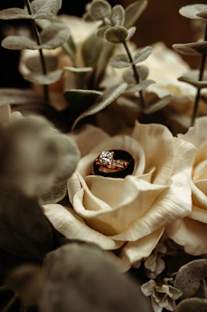 Close-up of a delicate custom engagement ring with intricate detailing on a velvet cushion.