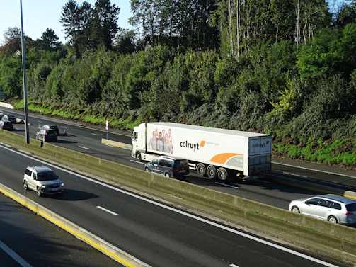 Fleet of delivery trucks on a highway, showcasing transport applications.