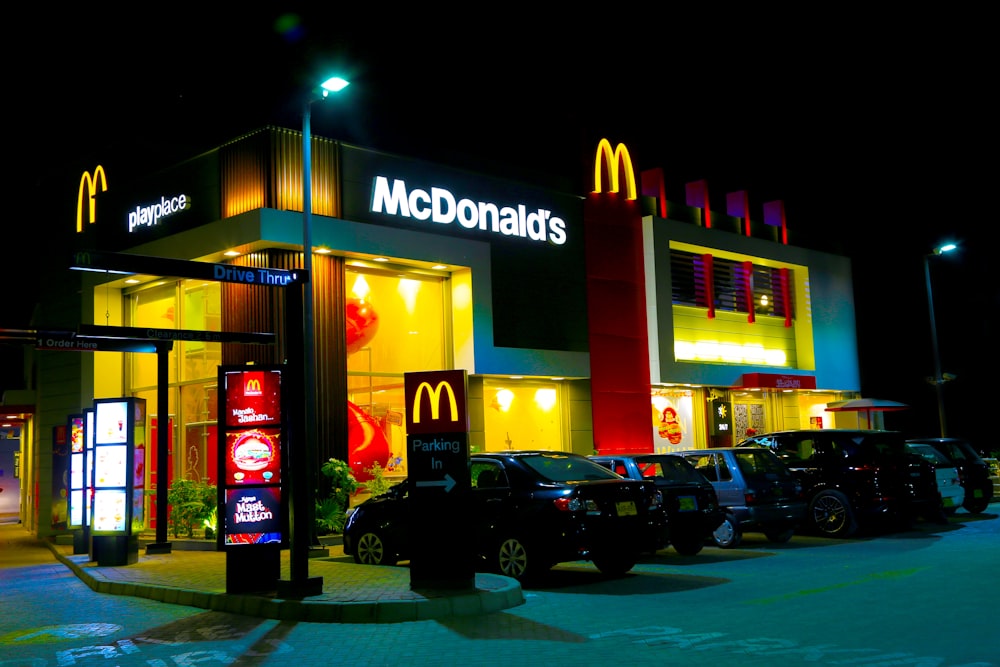 Cars parked in front of McDonald's restaurant during night time
