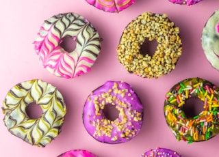 pink and green doughnut on white surface