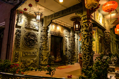 Traditional Thai wooden carvings and golden accents decorating the massage center’s entrance.