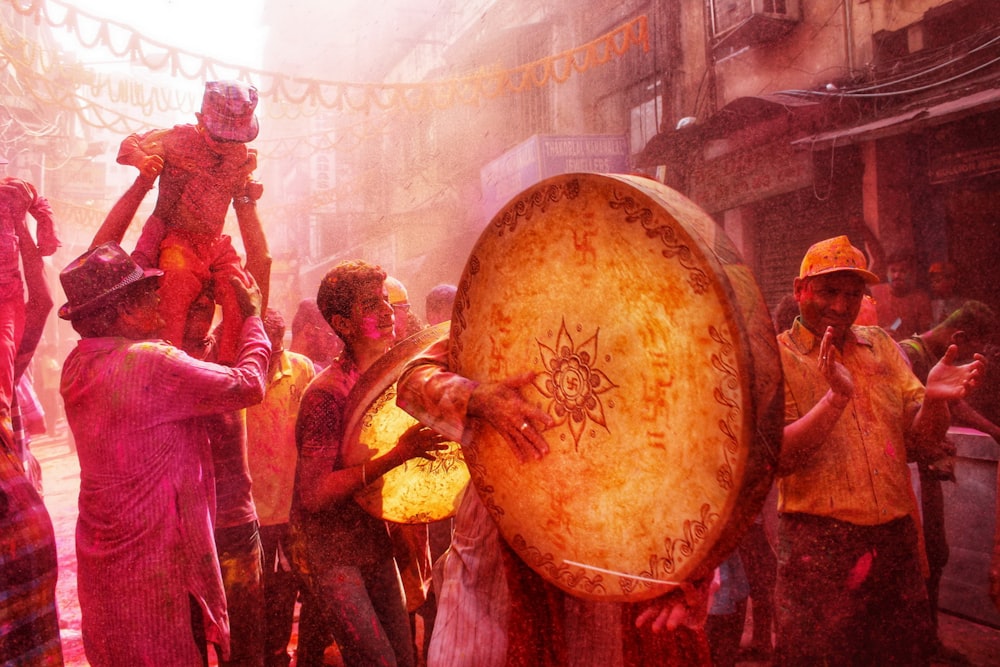 people in red and yellow dress dancing on street during nighttime