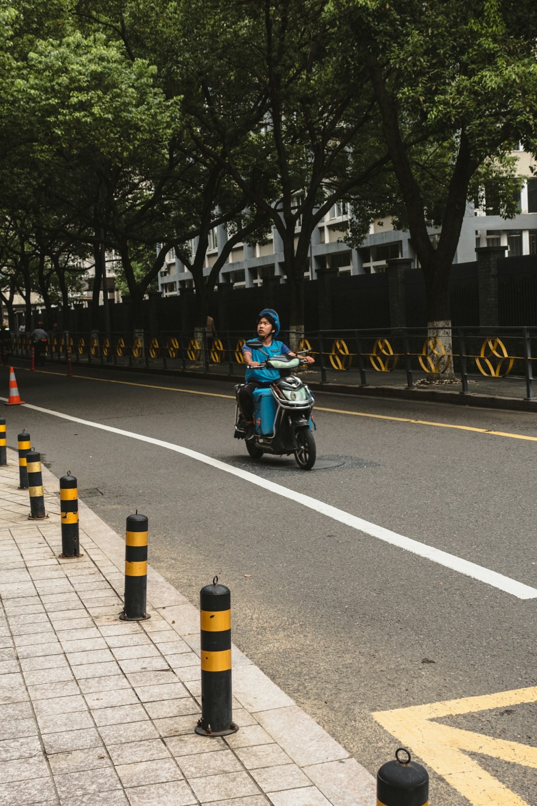 man in green shirt riding on green motorcycle on road during daytime