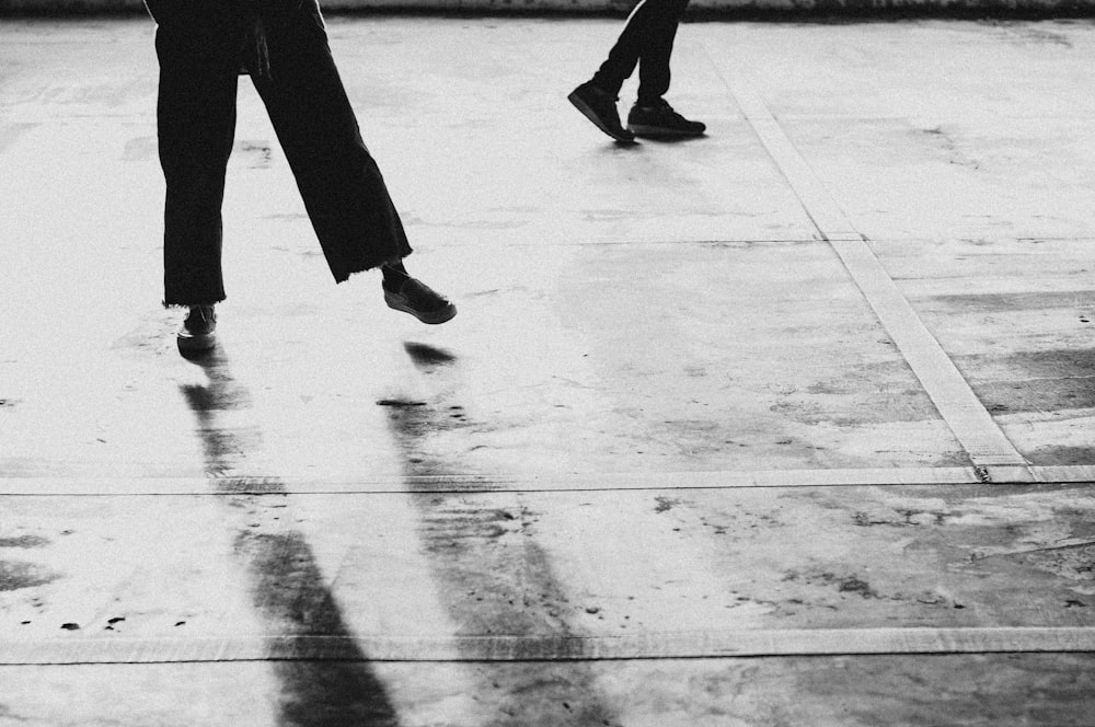 person walking on gray concrete floor