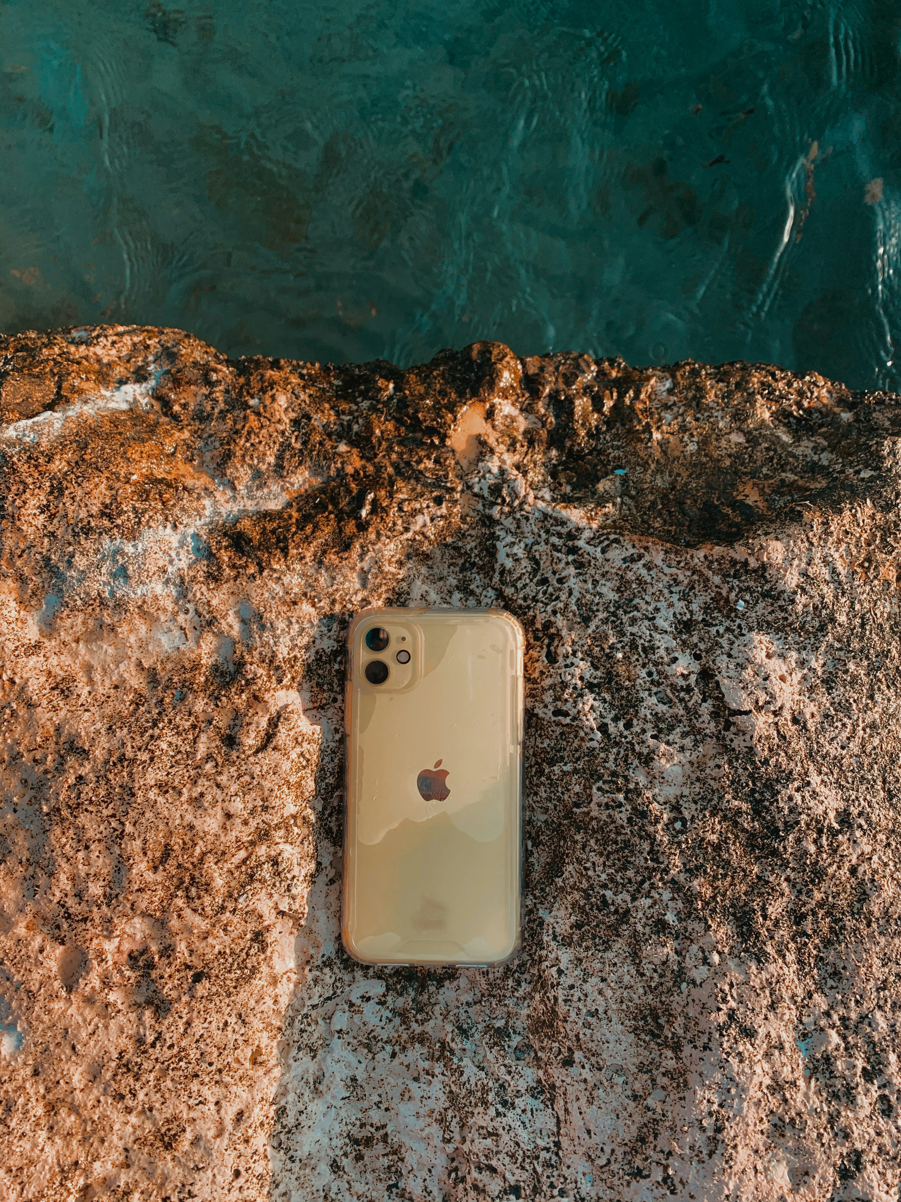 silver iphone 6 on brown and black rock