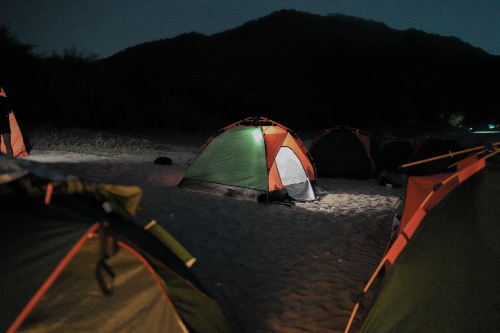 green and white tent on beach during night time