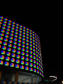 Curved LED screen wrapping around a building facade with colorful animations