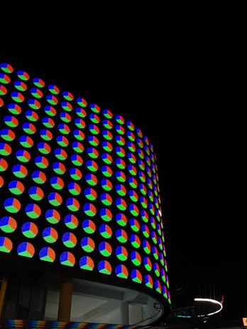 Curved LED screen wrapping around a building facade with colorful animations