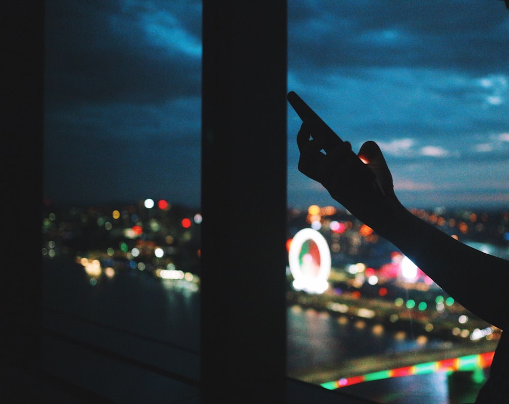 person holding black metal bar during night time