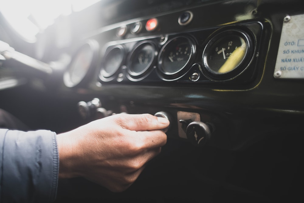 person holding car steering wheel