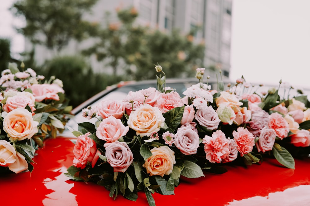 pink roses bouquet on red table