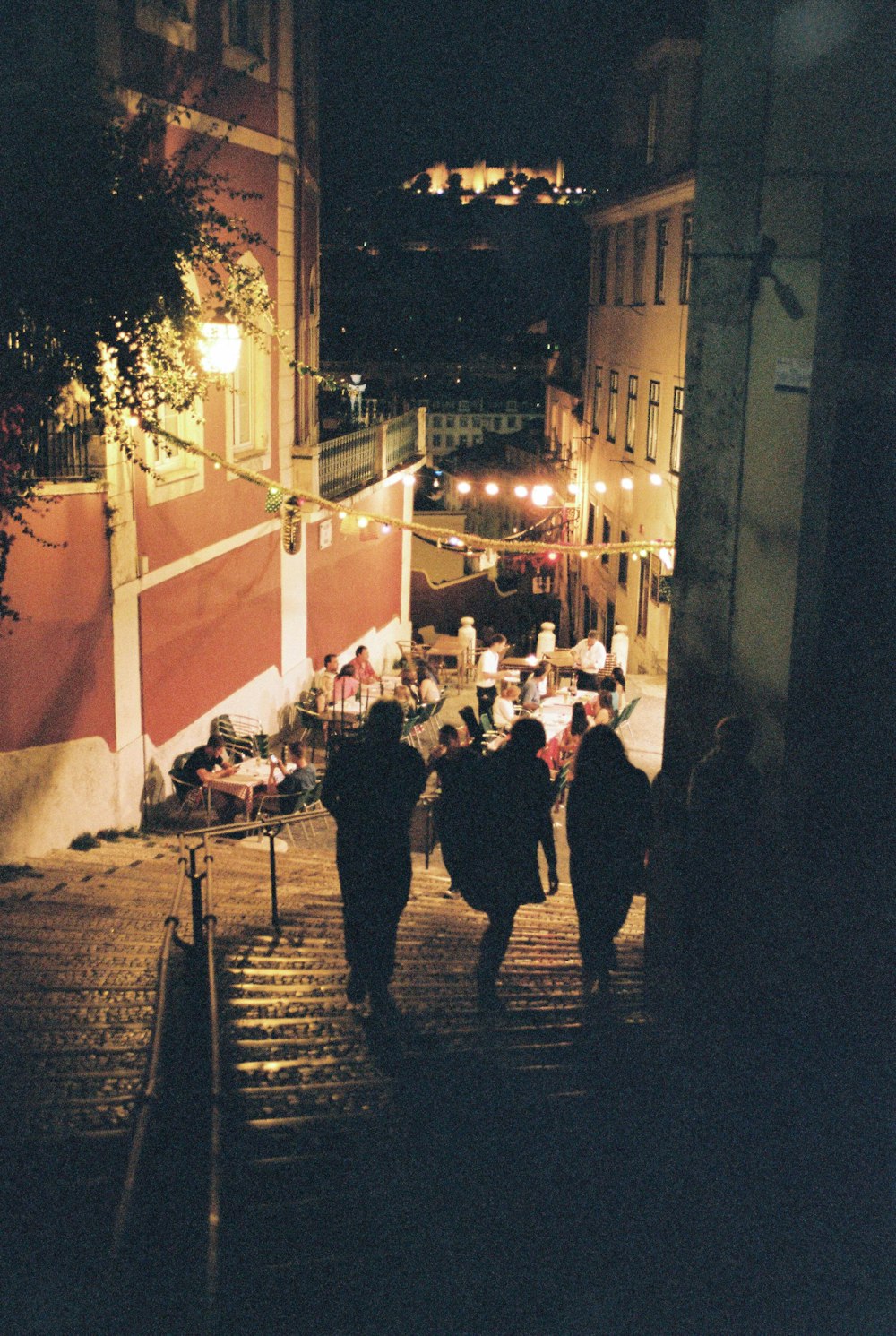 people walking on street during nighttime