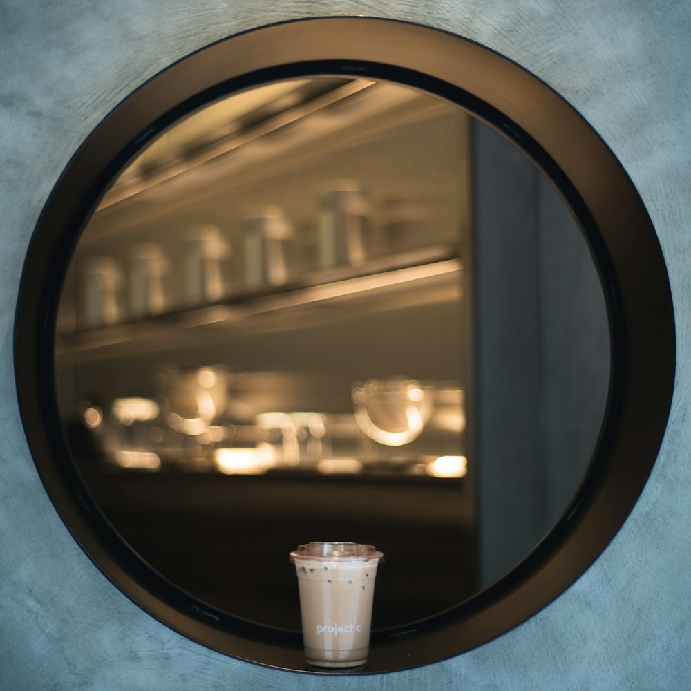 white plastic cup on round black frame