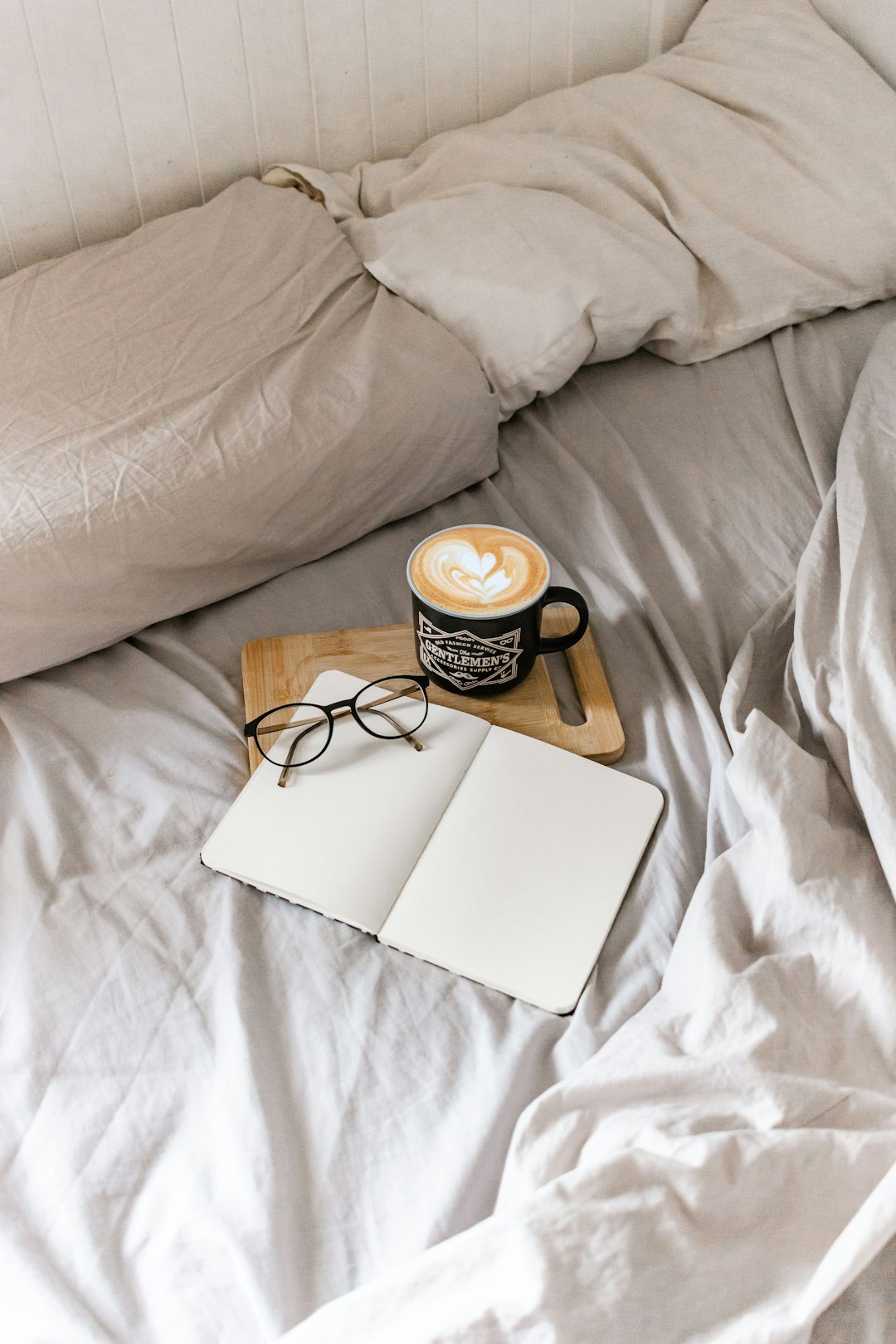 white and black ceramic mug on white book