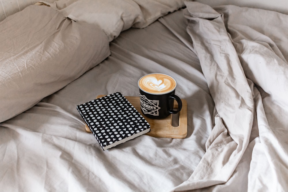 black and white ceramic mug on brown wooden tray