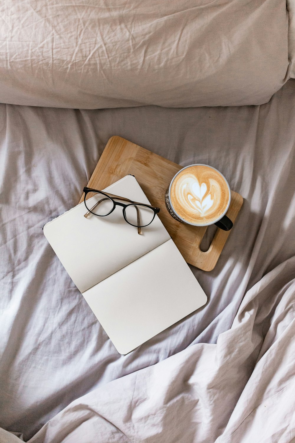 black framed eyeglasses on white paper