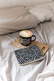 black and white polka dot ceramic mug on black and white book