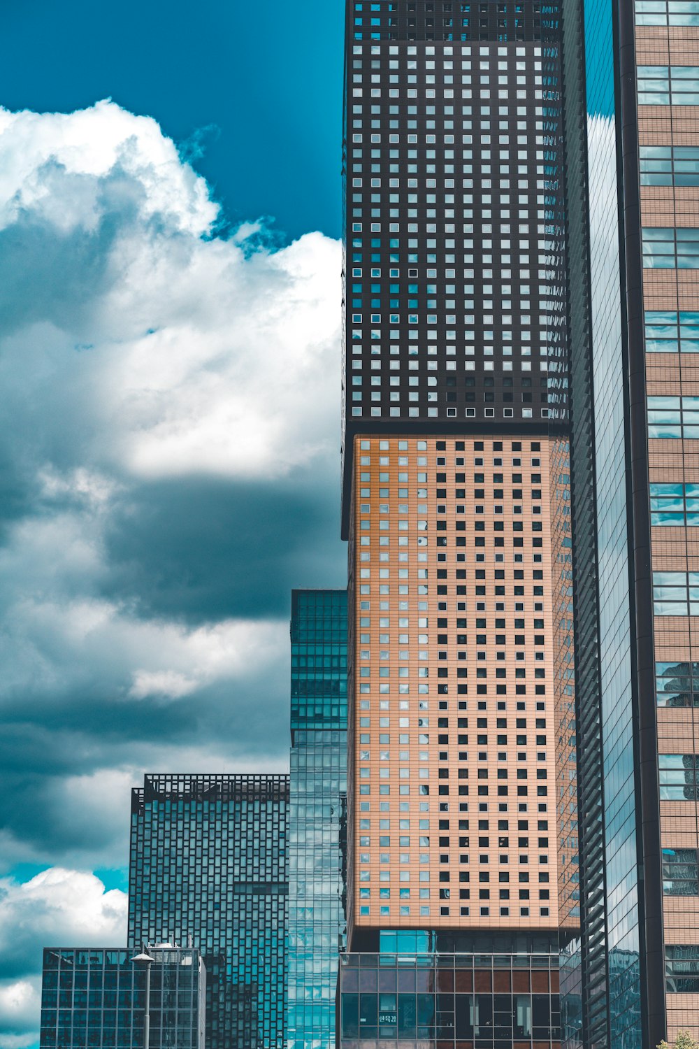 brown and black concrete building under blue sky