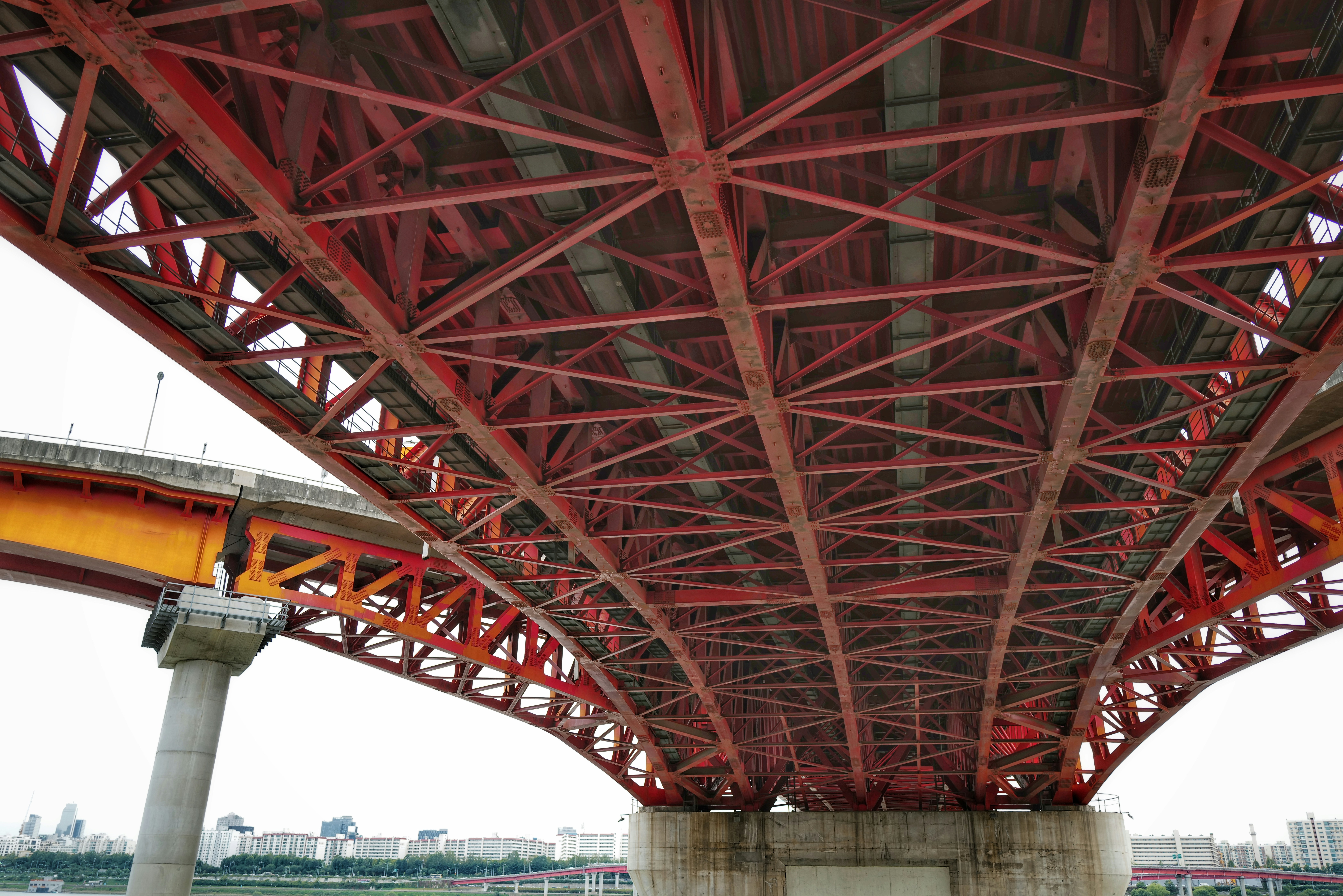 Puente de metal rojo sobre el cuerpo de agua durante el día