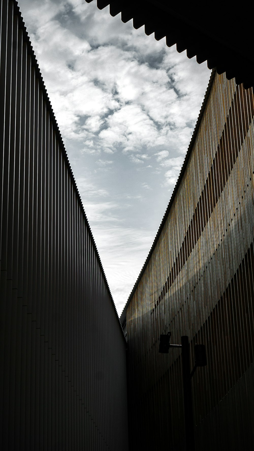 brown concrete building under white clouds during daytime