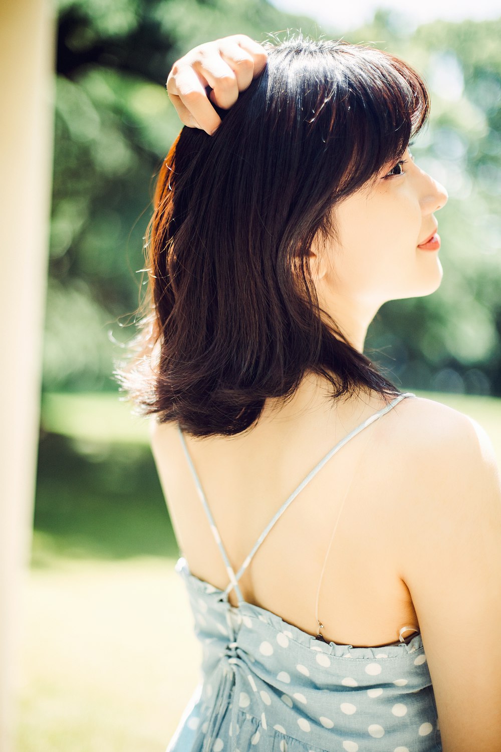 woman in white spaghetti strap top