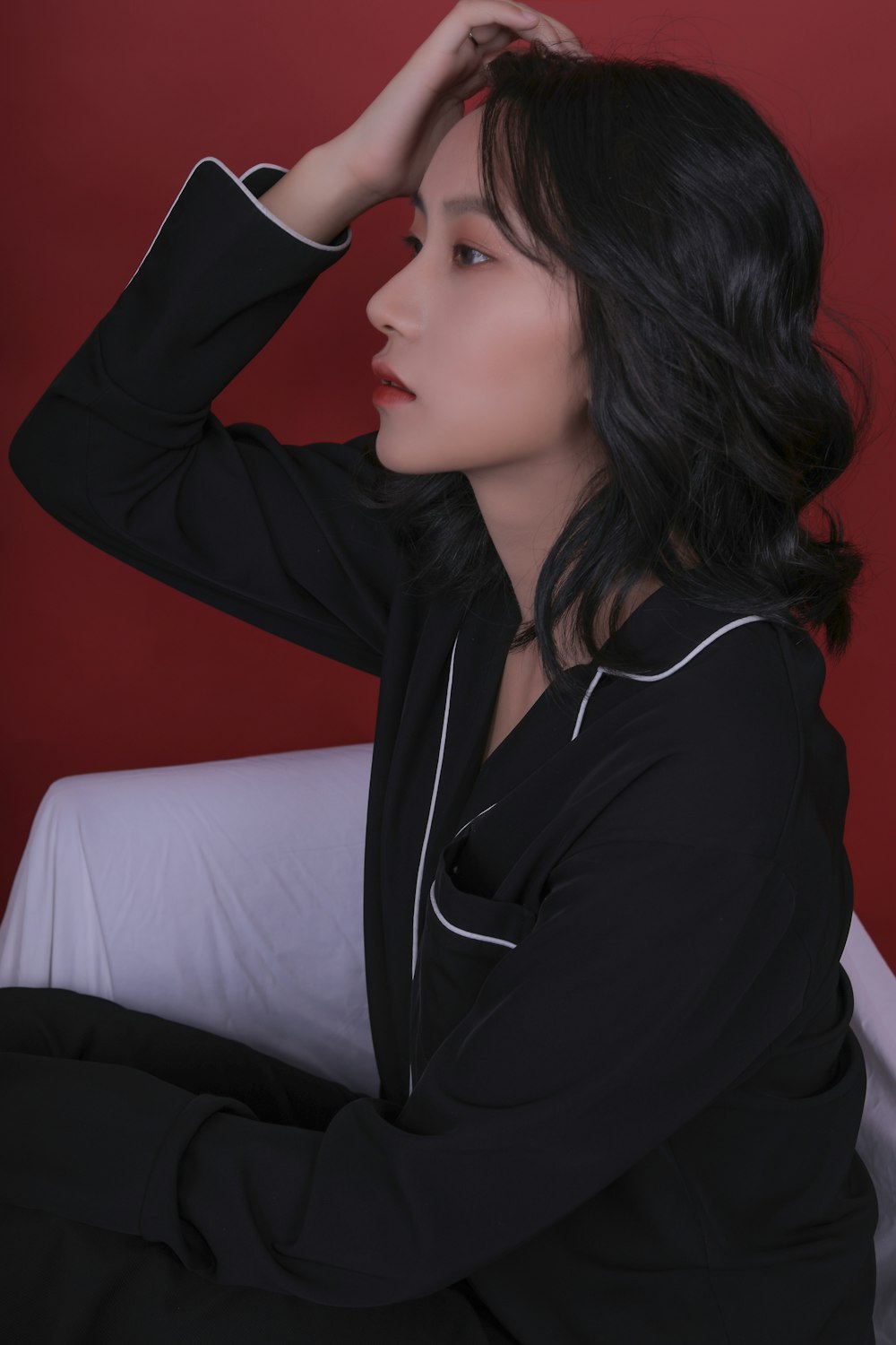 woman in black long sleeve shirt sitting on white sofa