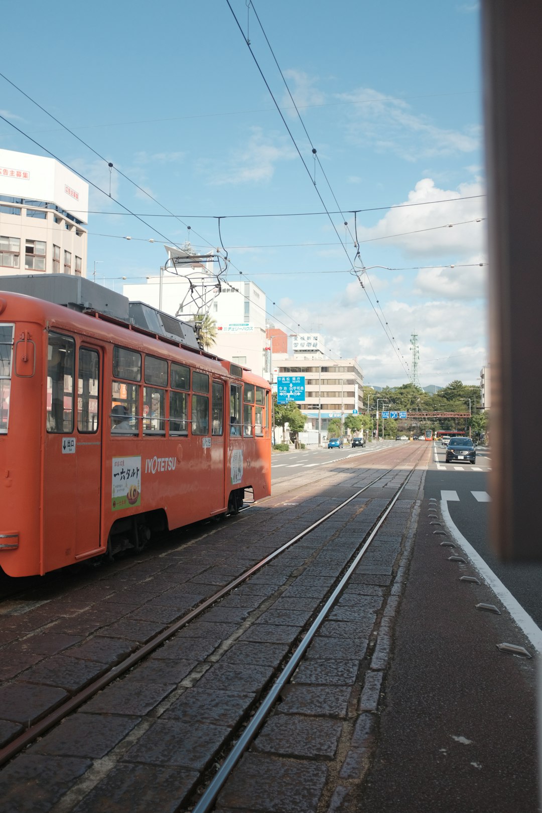 red and white tram on road during daytime