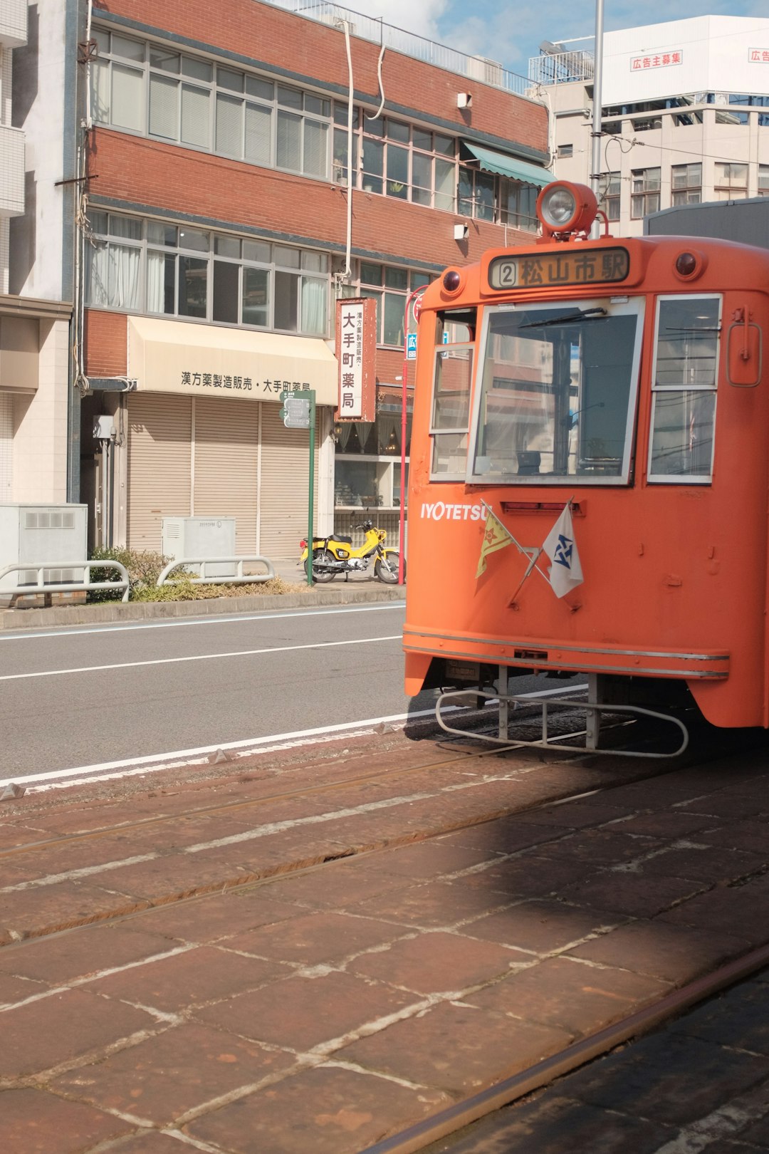 red and yellow tram on road during daytime