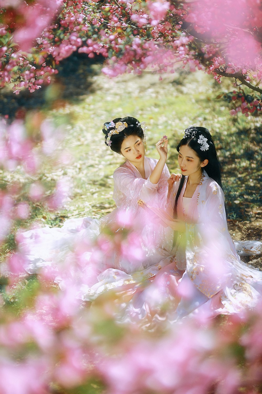 woman in pink dress lying on pink flowers