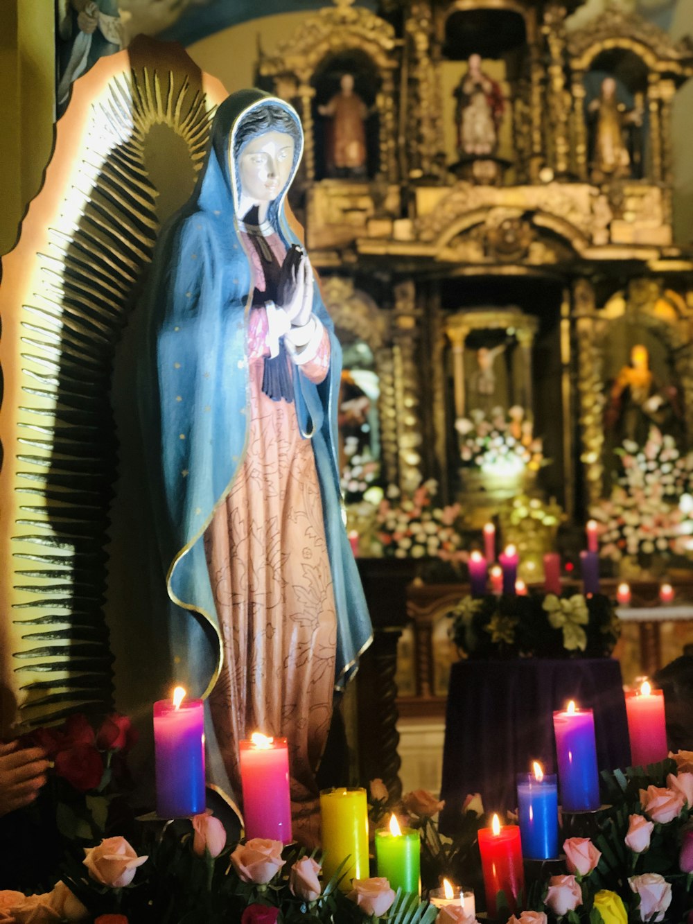 virgin mary statue with candles