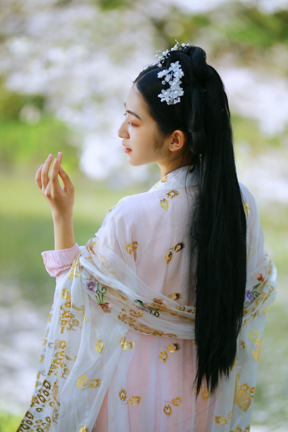 woman in white and yellow floral long sleeve dress