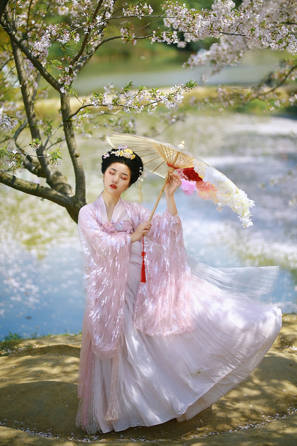 woman in pink and white floral dress with white and black floral headdress