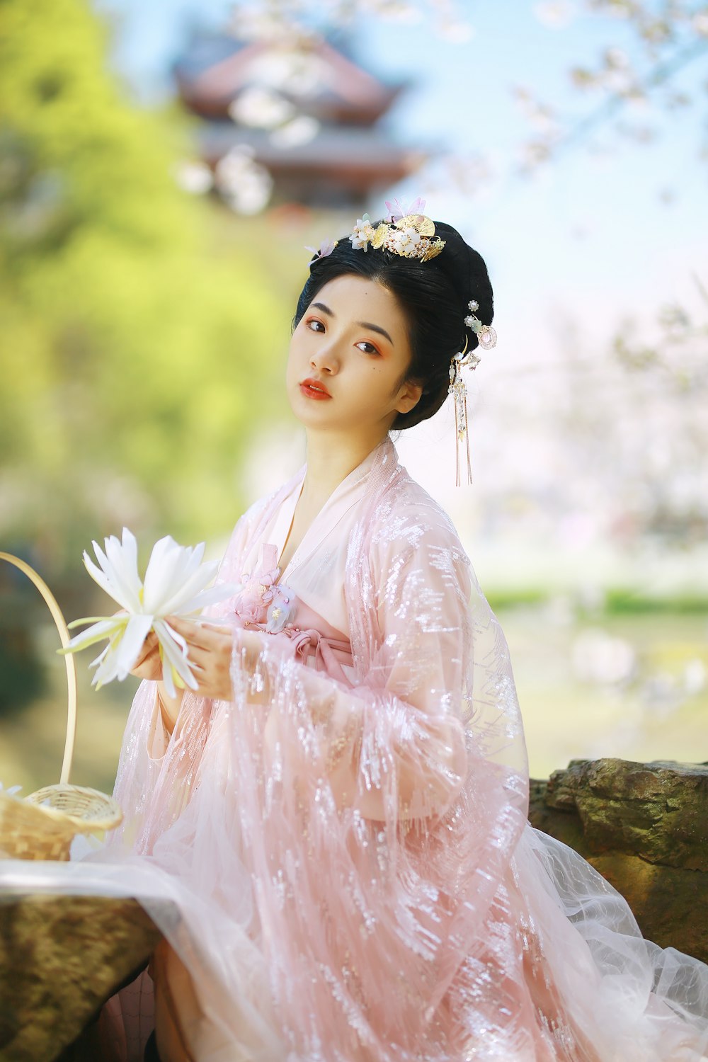 woman in pink dress with white flower headband