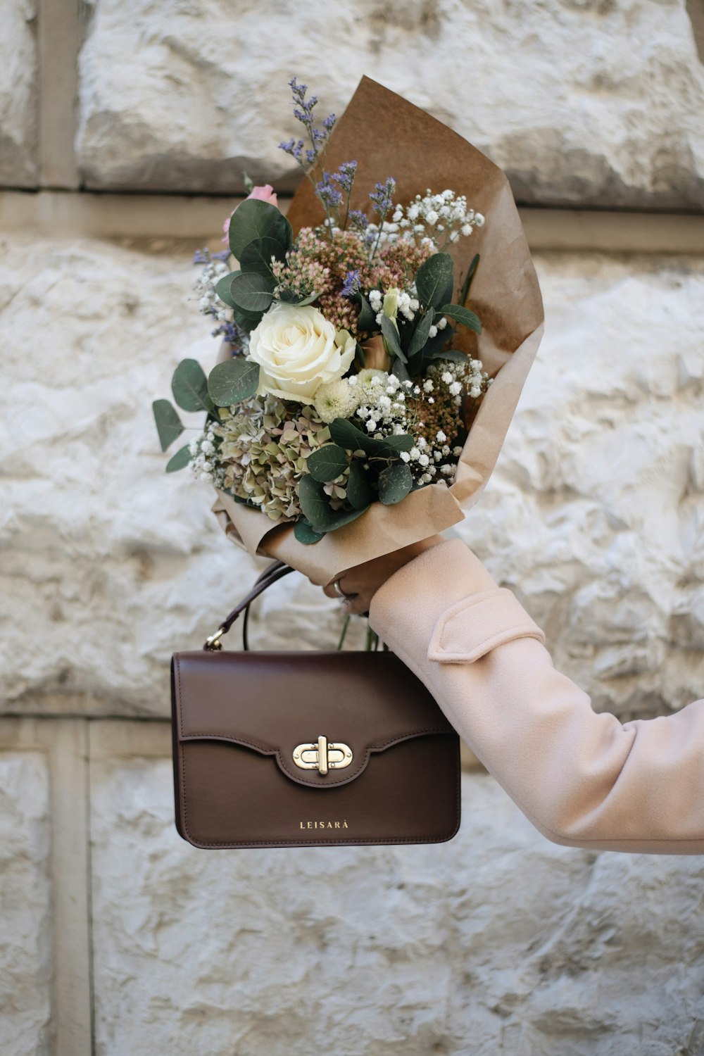 person holding bouquet of flowers