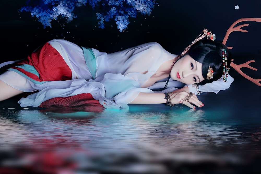 woman in white and red dress lying on water