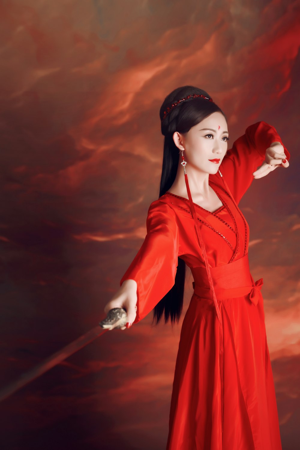 woman in red long sleeve dress holding stick