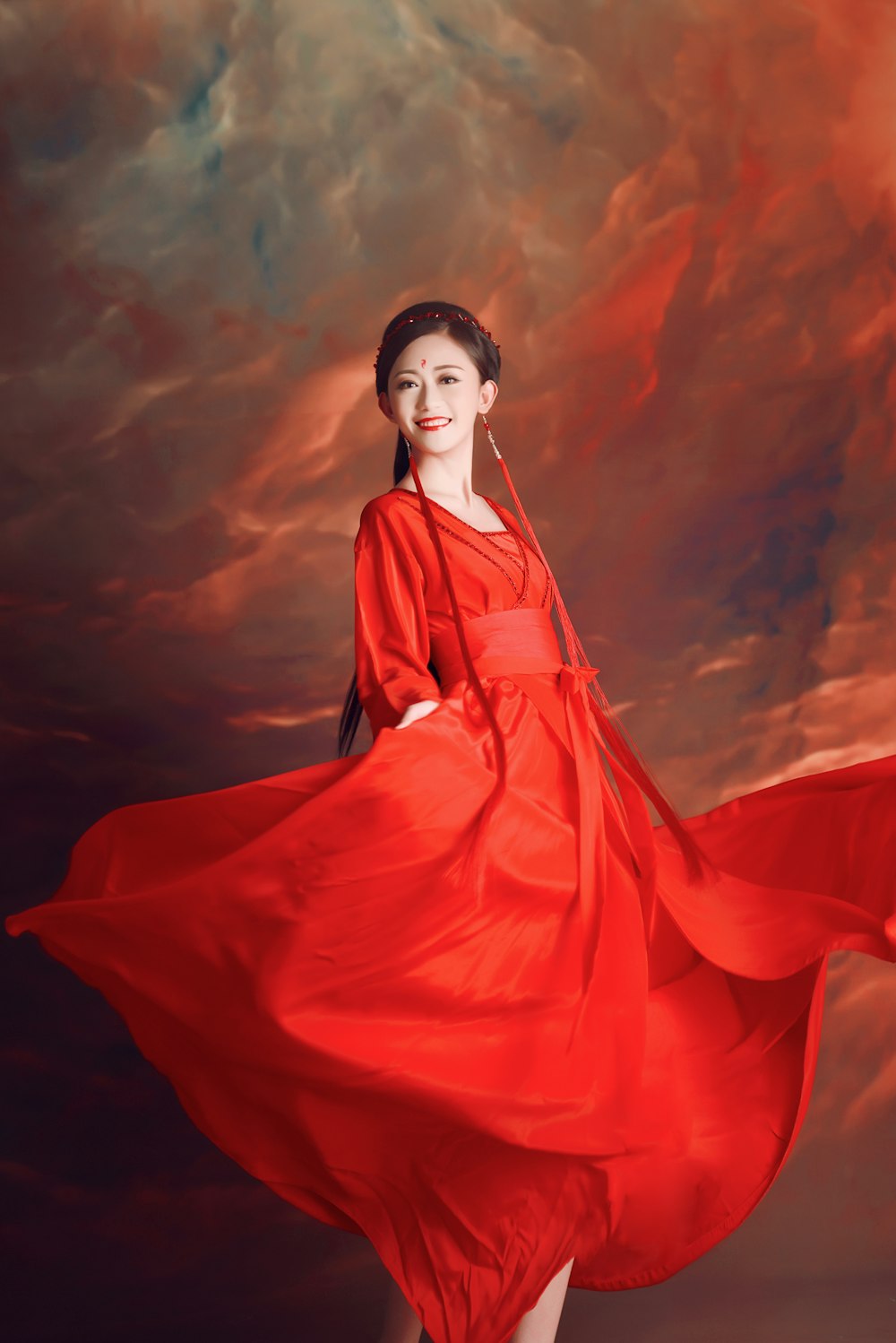 Mujer en vestido rojo bajo cielo azul durante el día