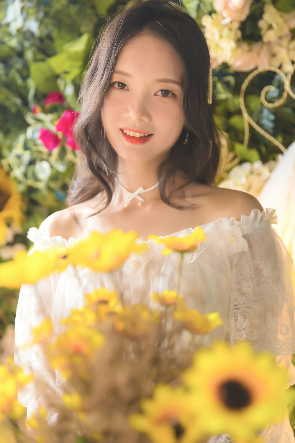 woman in white off shoulder dress smiling