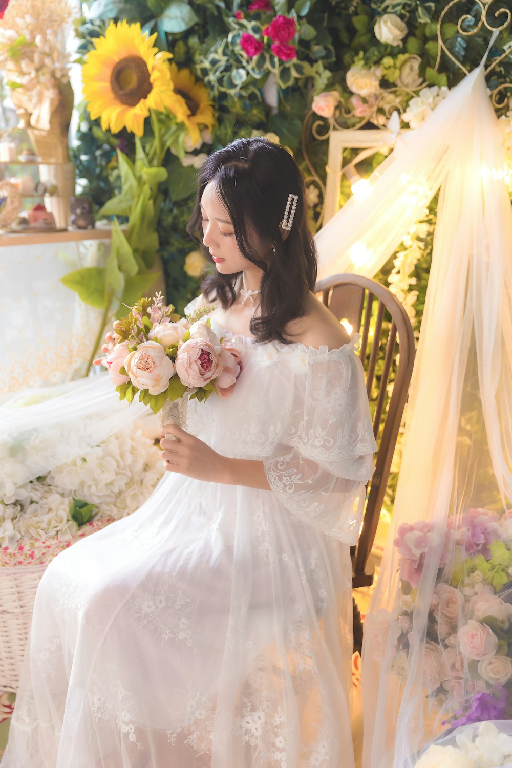 woman in white wedding dress holding bouquet of flowers