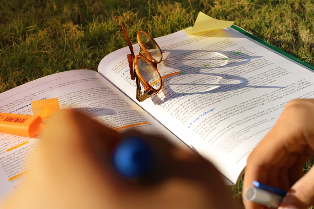 brown framed sunglasses on book page