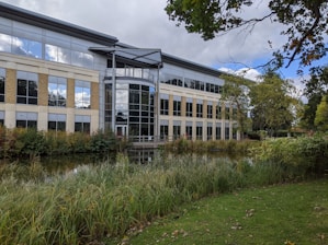white and brown concrete building near green grass field during daytime