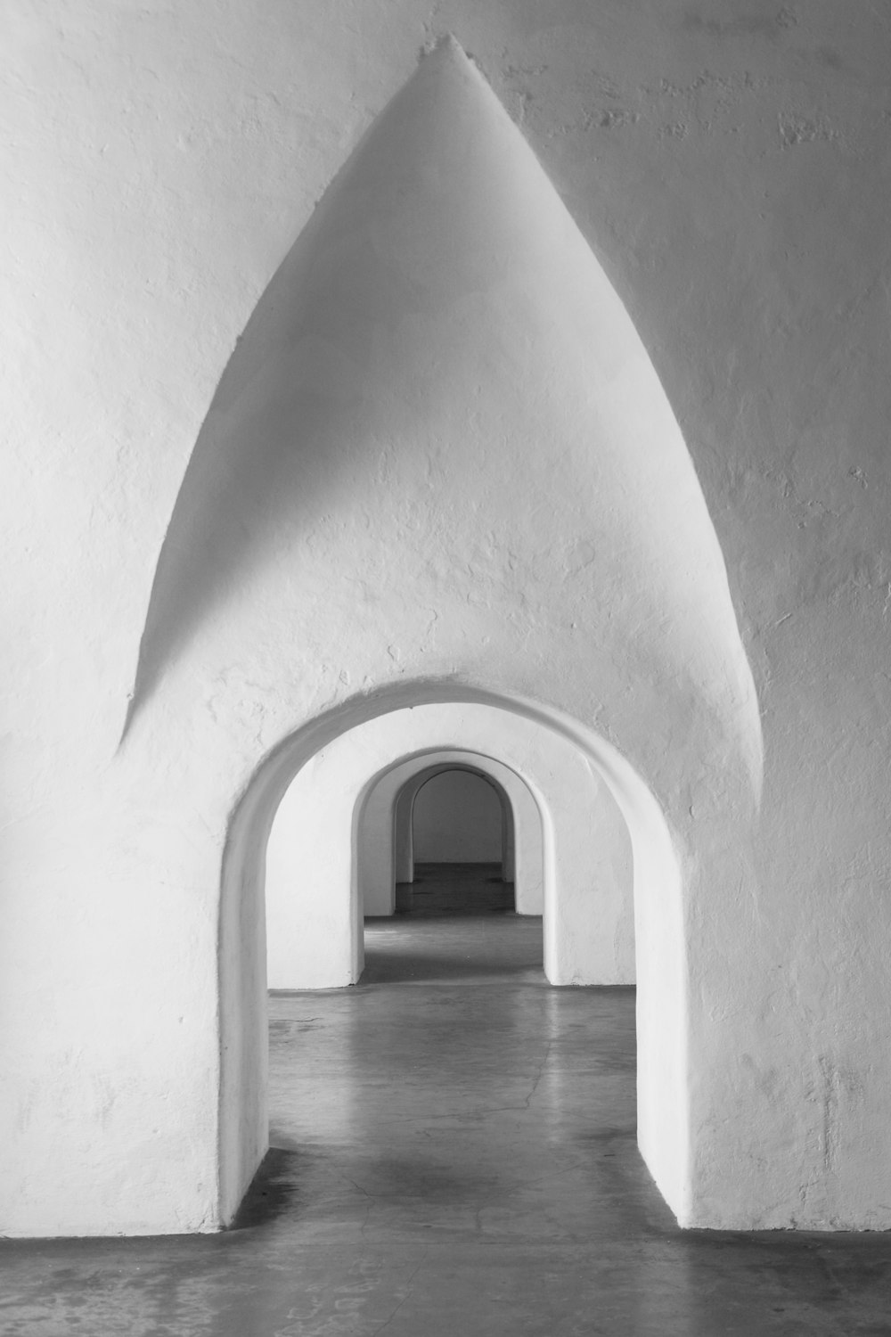 grayscale photo of person walking on hallway