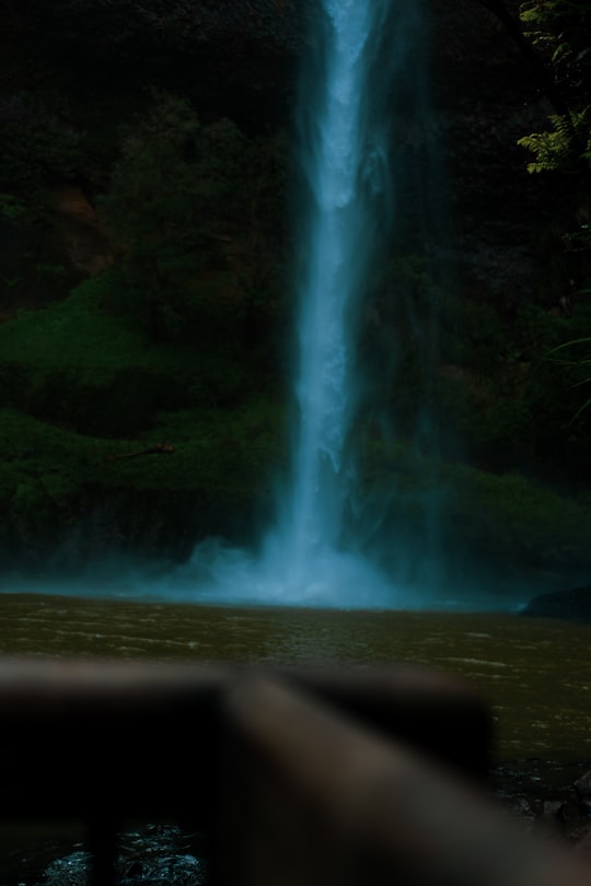 waterfalls on brown rocky mountain during daytime in Hamilton New Zealand