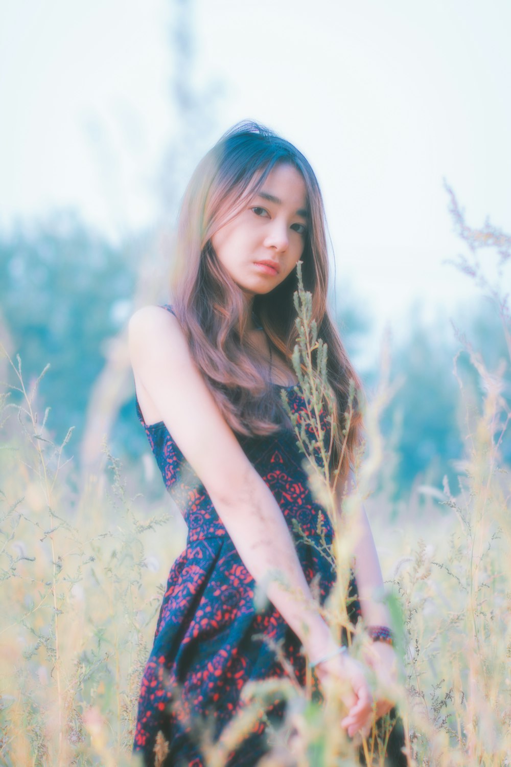 woman in blue and white floral sleeveless dress