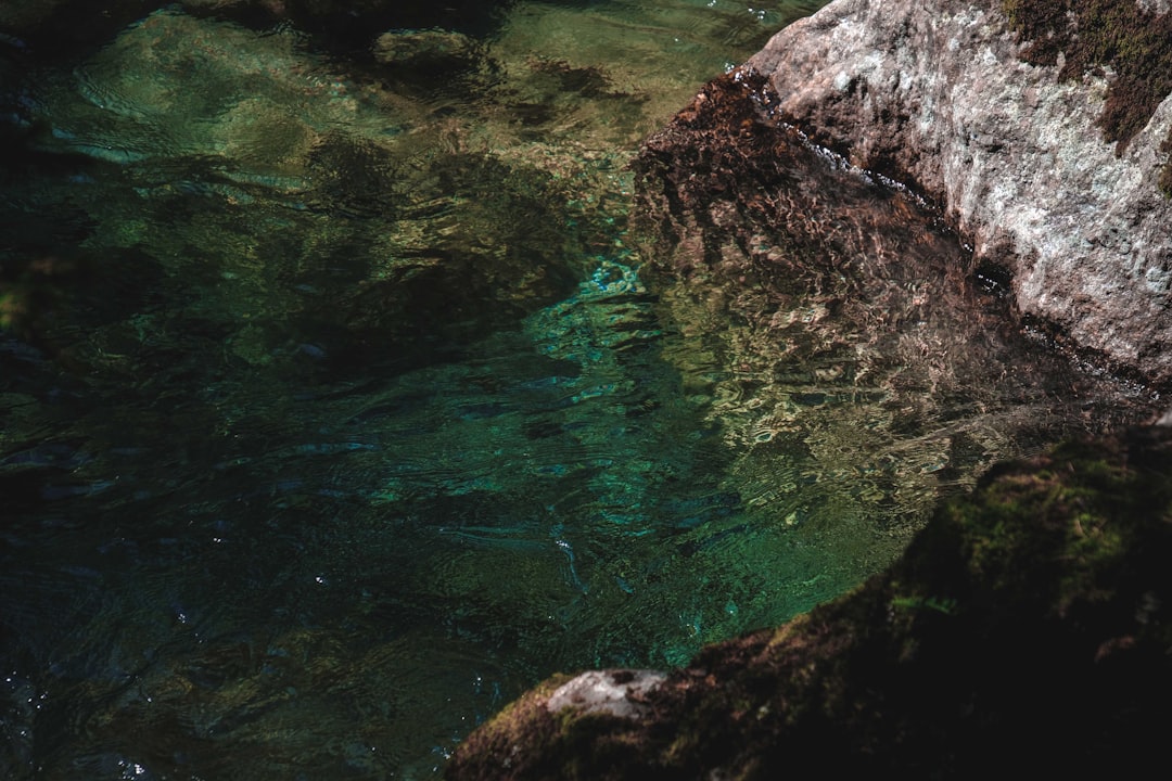 green water and brown rock