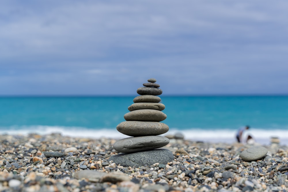 stack of stones on beach during daytime