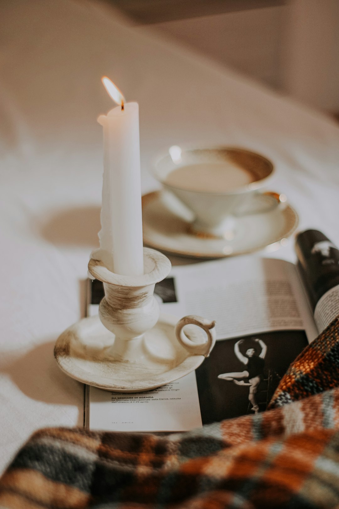 white candle on white candle holder