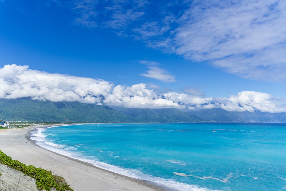 blue sea under blue sky and white clouds during daytime