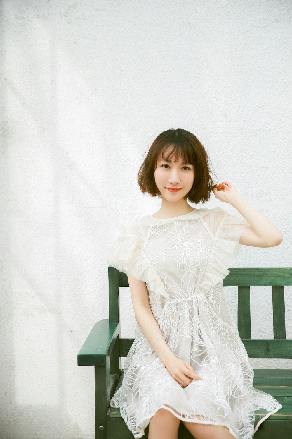 girl in white dress sitting on chair