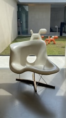 white plastic armchair on gray concrete floor